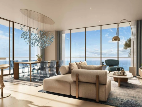 Contemporary apartment interior with oceanfront views, featuring stylish furnishings, a dining table, and a modern chandelier