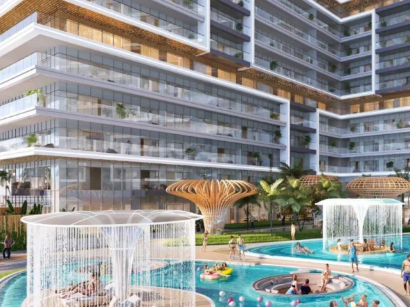 Stunning pool area at Damac Shoreline, Al Marjan Island, featuring cascading waterfalls, palm trees, and a modern building complex.