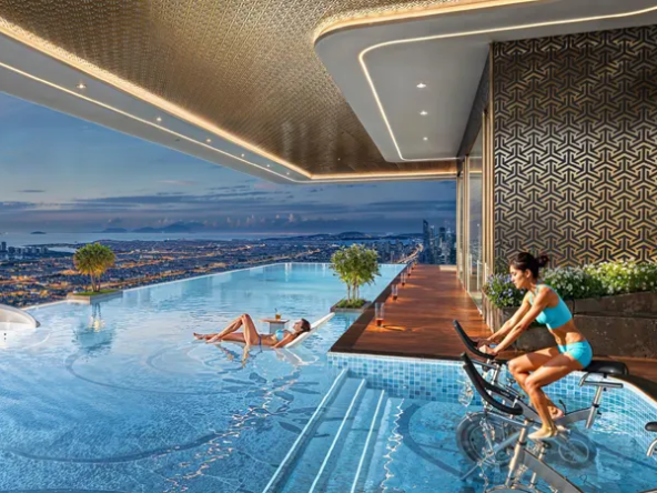 Luxurious rooftop amenities at Bayz 102 residential tower, featuring a swimming pool and exercise equipment.
